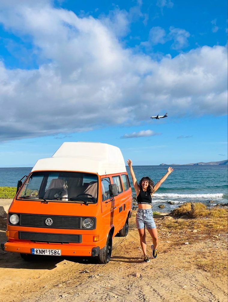 Marchela by her campervan at the beach
